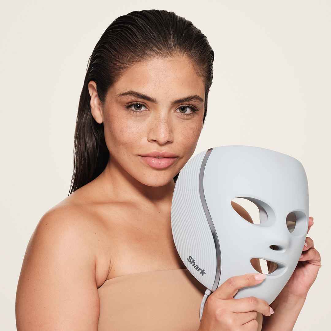Woman applying an LED mask as part of her skincare routine