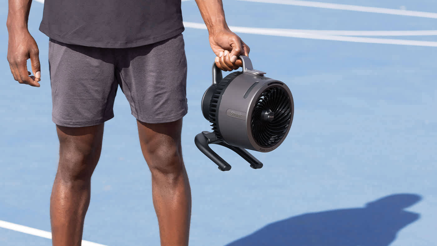 Image of man holding the Shark Hydro Go Fan 